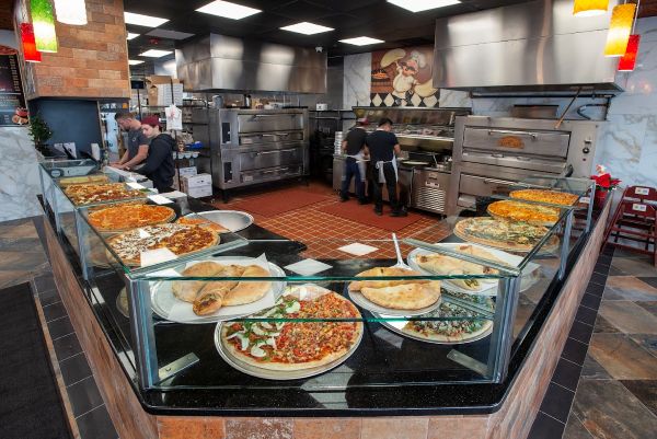 Inside Anthony Francos in Springfield NJ, a large kitchen filled with delicious pizzas, each topped with different ingredients.