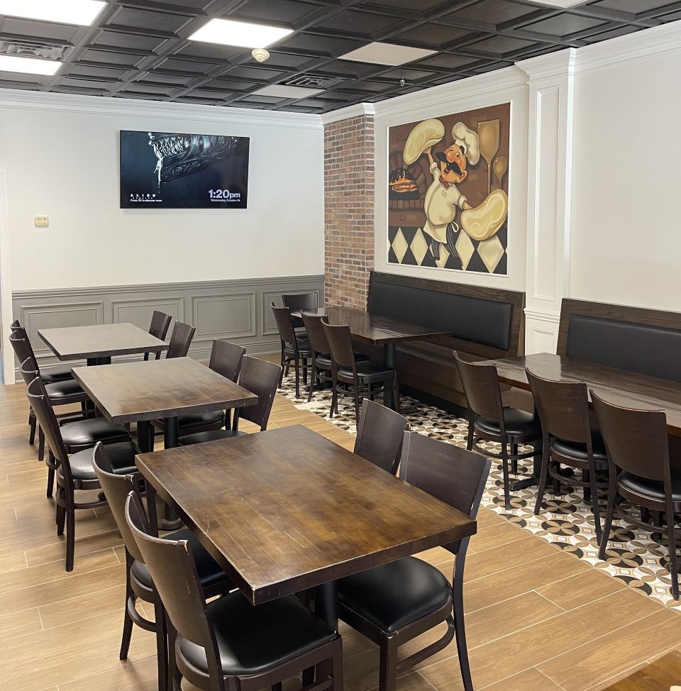 Newly renovated dining room at Anthony Franco's Pizza, featuring tables and chairs, ideal for gatherings and parties.