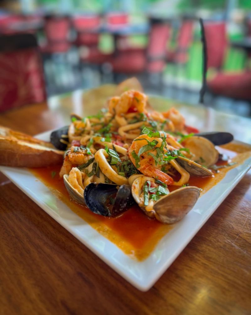 A delicious plate of mussels and bread served at Anthony Francos in Sparta, NJ, ready to enjoy on a cozy table.